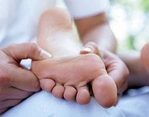 Image of practitioner applying shiatsu massage to a client's foot 