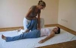 Image of the therapist stretching the knee and hip of a patient 