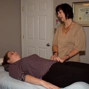 Susan Mosley, DACM performing an examination on a patient 