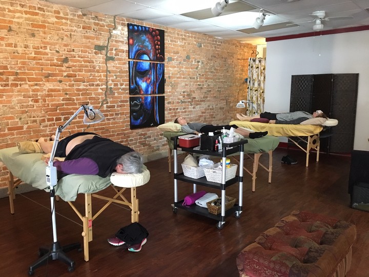 Image of several patients receiving treatments in recliners in the group acupuncture clinic